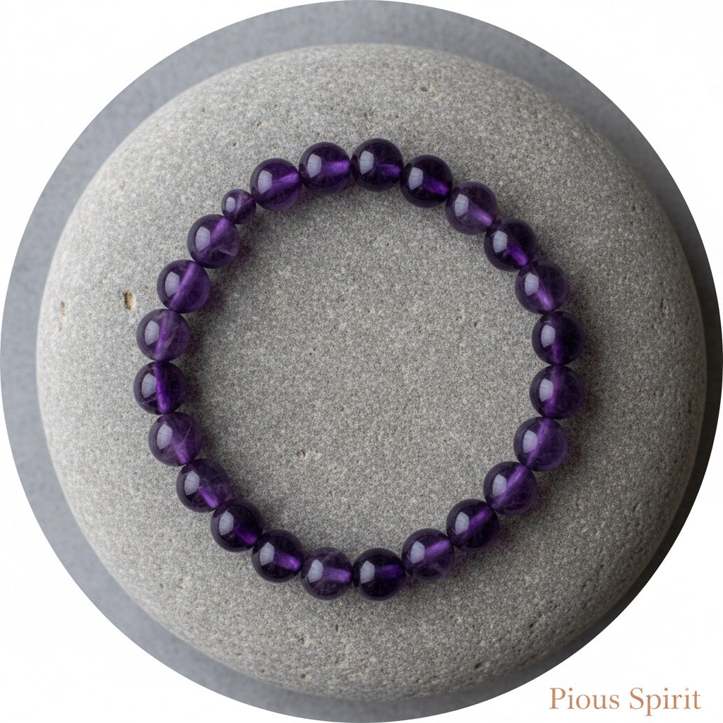 Purple amethyst bead bracelet displayed on a smooth gray stone with round shape