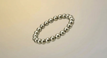 Silver metallic bead bracelet on neutral gradient background