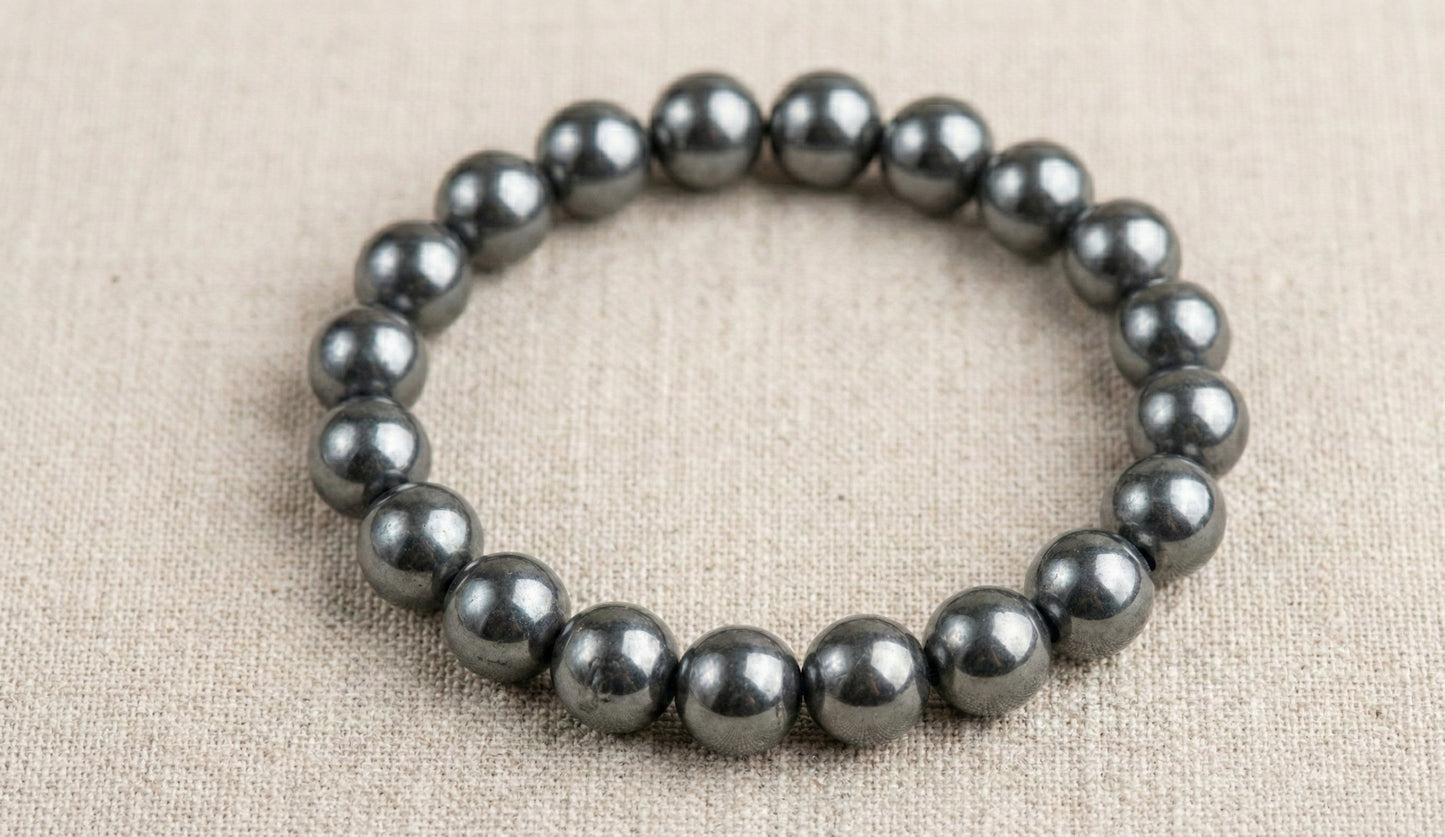 Hematite bead bracelet on beige fabric background